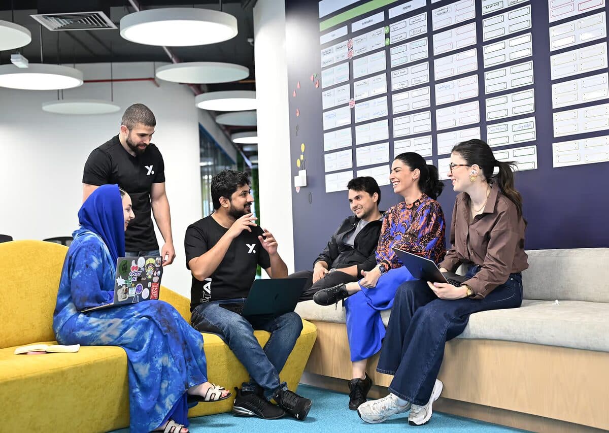 The team on the couch, laptops open